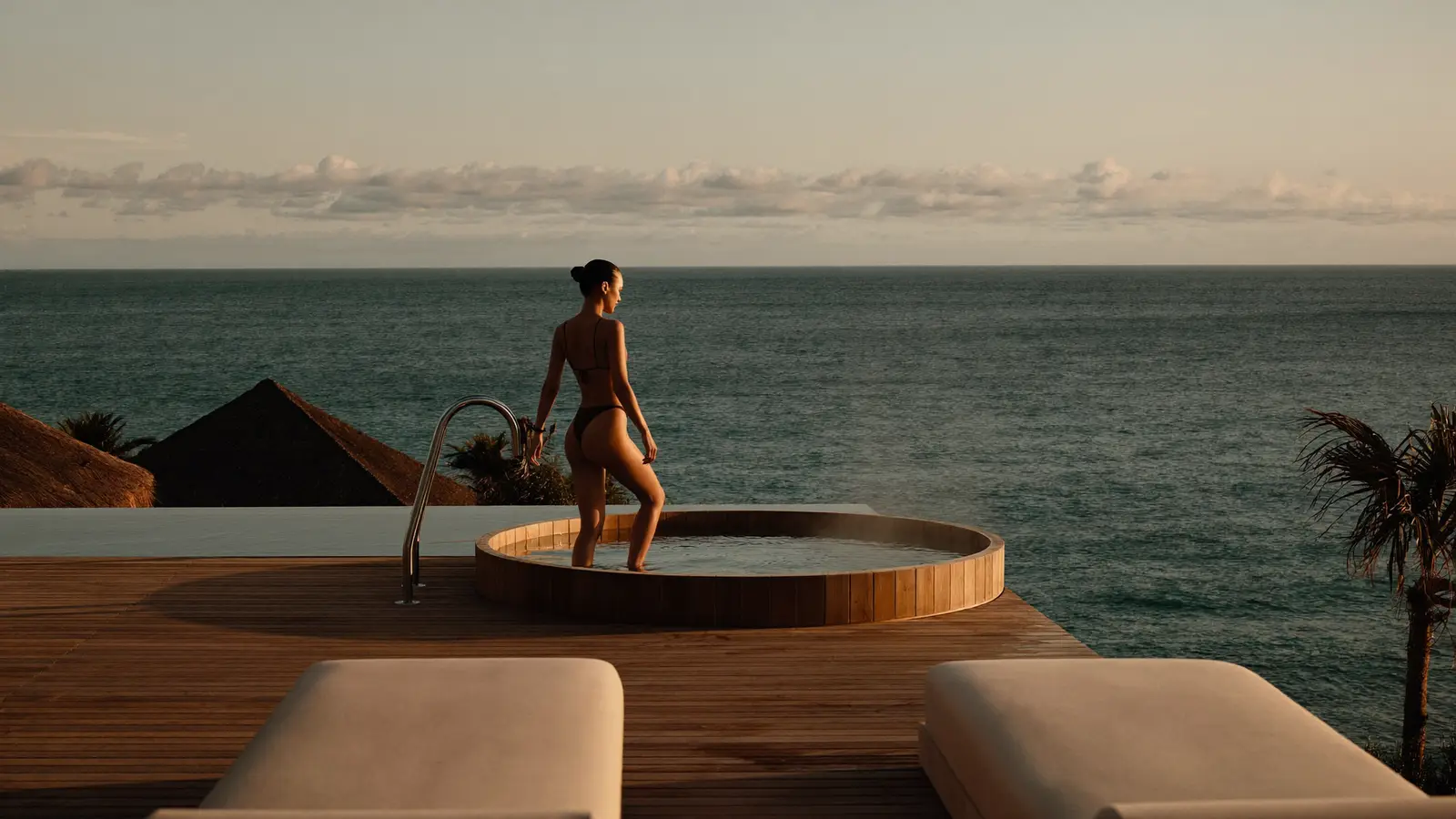 Guided cold plunge ice bath on an ocean deck at golden hour on a Bali wellness retreat