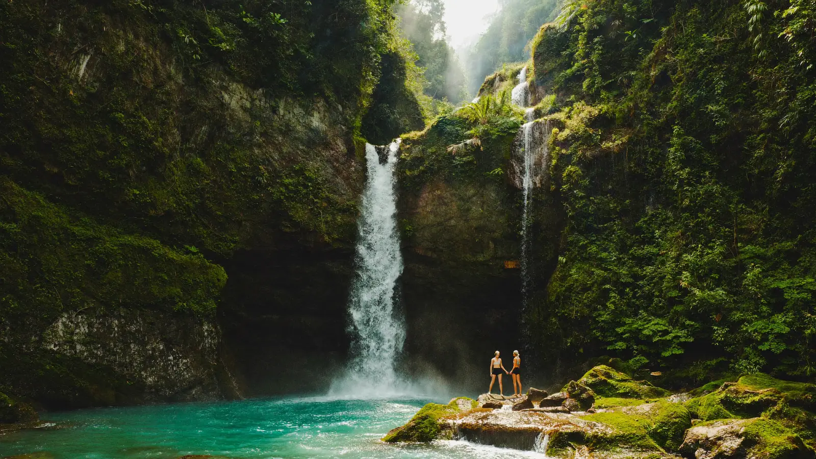 Lush Bali jungle waterfall with turquoise pool on a wellness retreat excursion